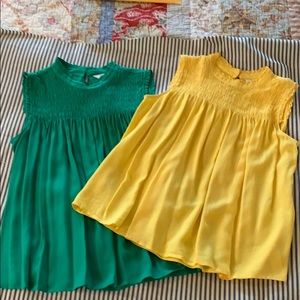 Flowing smocked sleeveless top with ruffle collar.